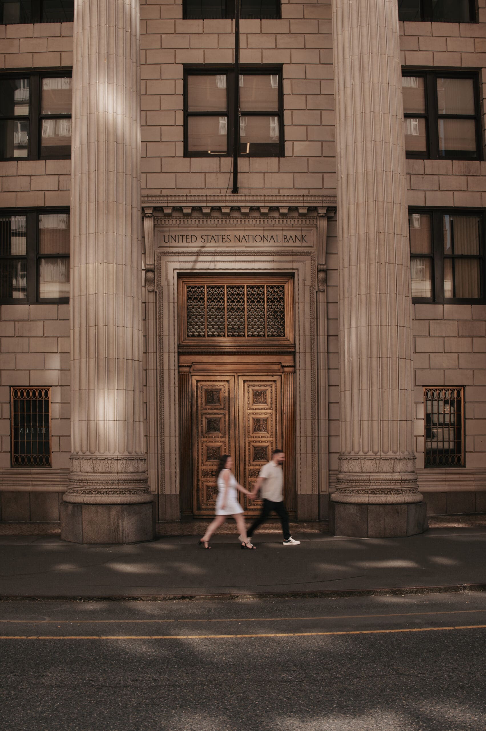 Engagement photo in front of a historic Downtown Portland building, featuring architectural details for Portland elopement photography.