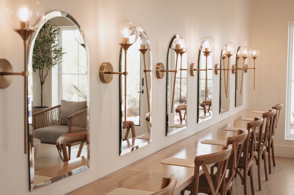 Bridal prep room with arched mirrors and sconces lining the wall at Desert View Wedding and Events.