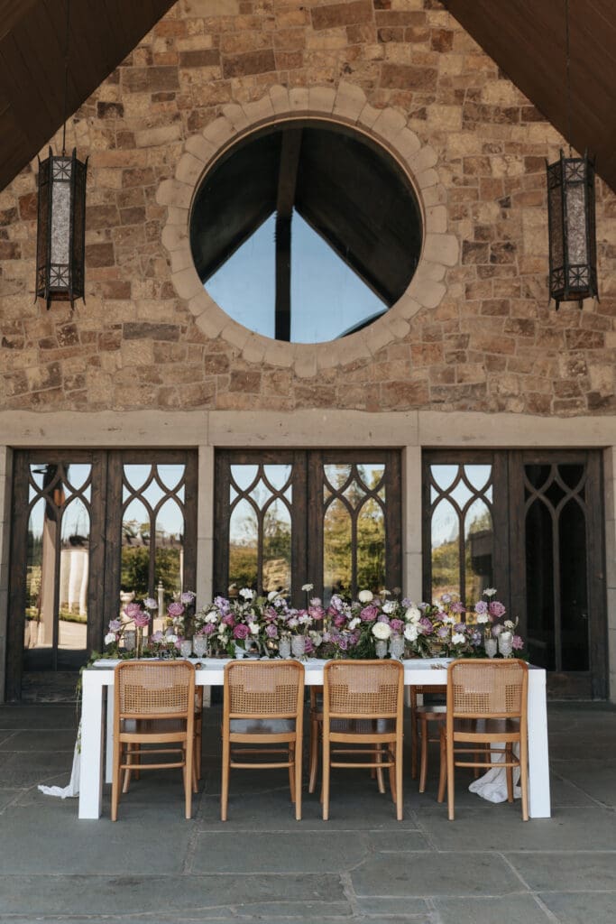 Elegant wedding reception table decor with florals at Chateau de Lis