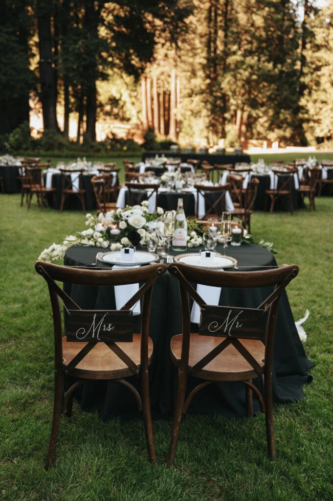 Sweetheart table and reception layout surrounded by towering trees at Nestldown captured by Nestldown wedding photographer.