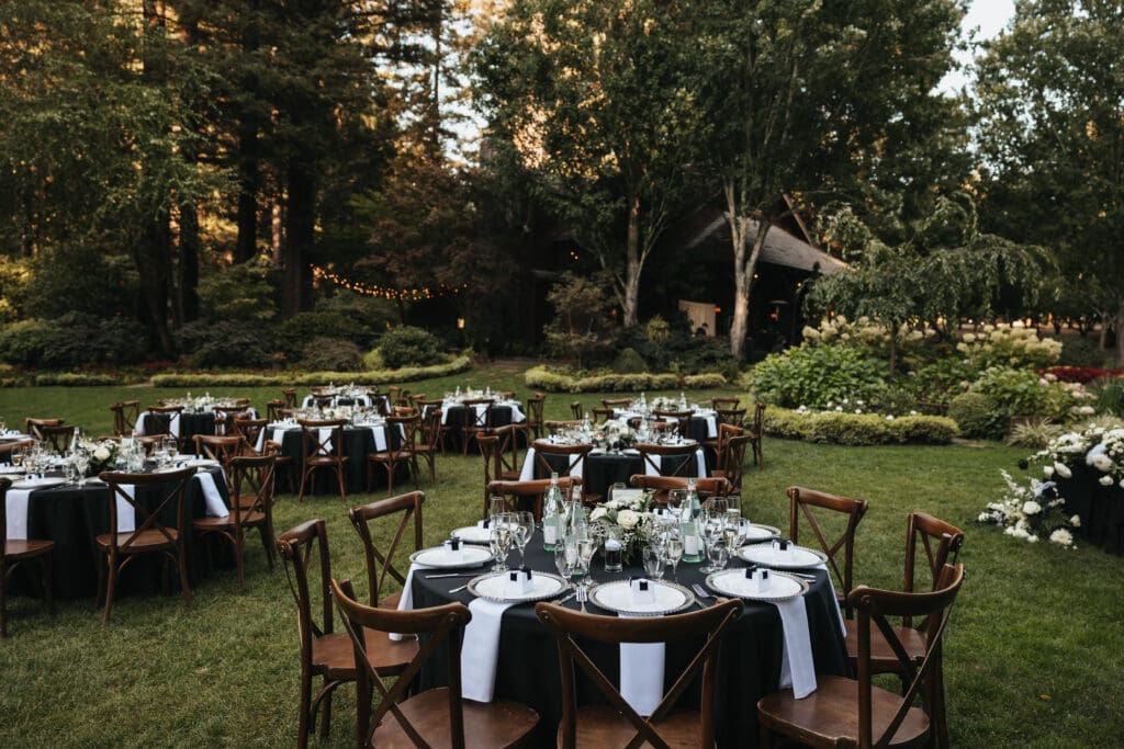 Reception layout surrounded by towering trees at Nestldown wedding venue in Northern California.