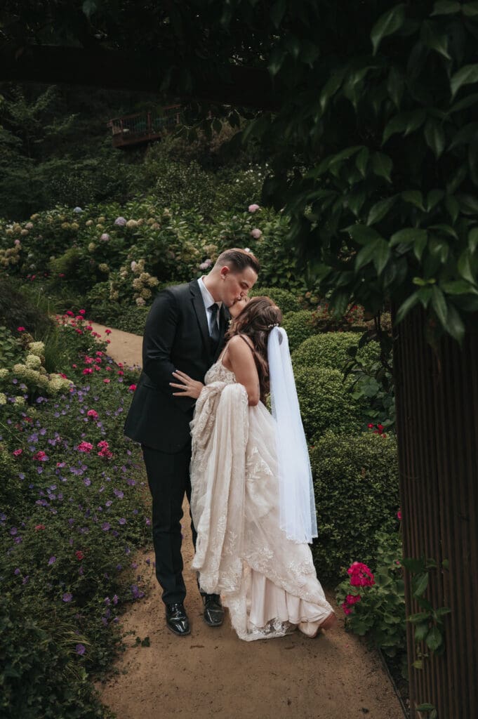 Bride and groom embracing in the gardens during golden hour at Nestldown in Los Gatos.
