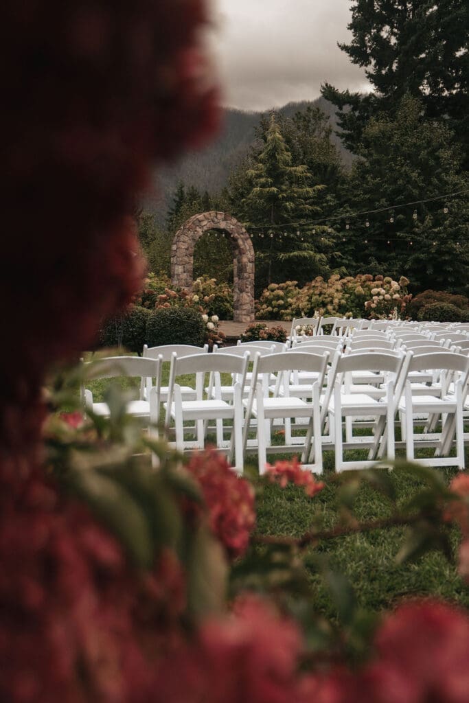 Outdoor wedding ceremony with scenic mountain backdrop at Cape Horn Estate framed by hydrangeas.