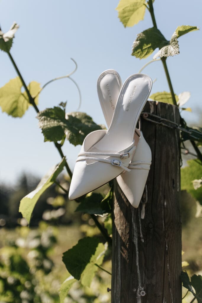 Bridal shoe detail photographed among the gardens at Villa Catalana Cellars wedding venue.