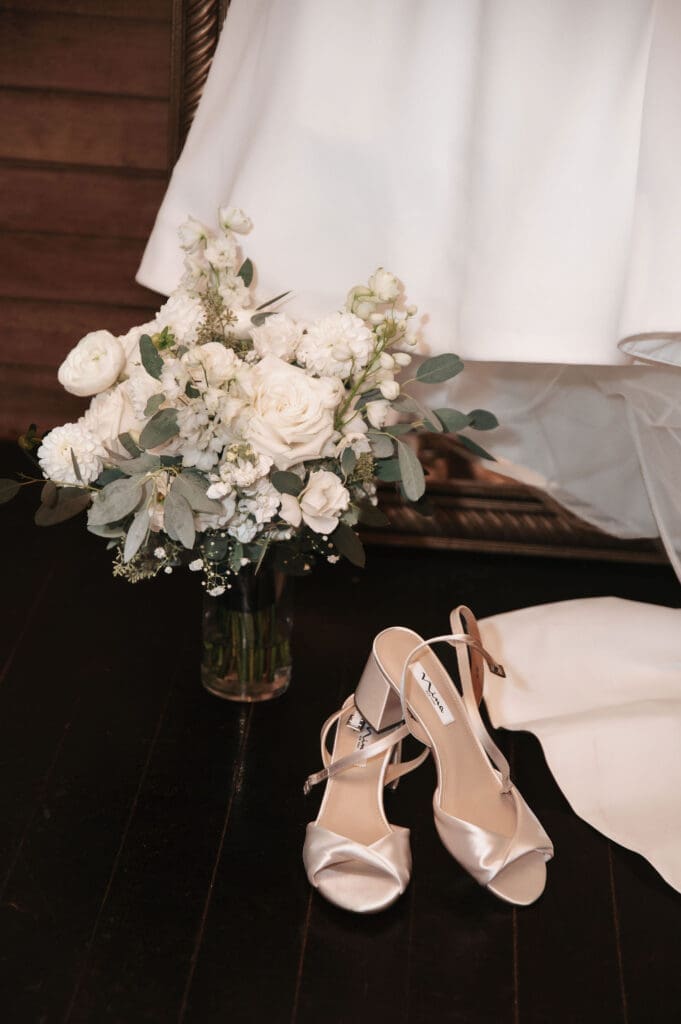Flashy detail shot of bride's dress, shoes and bouquet prior to wedding.
