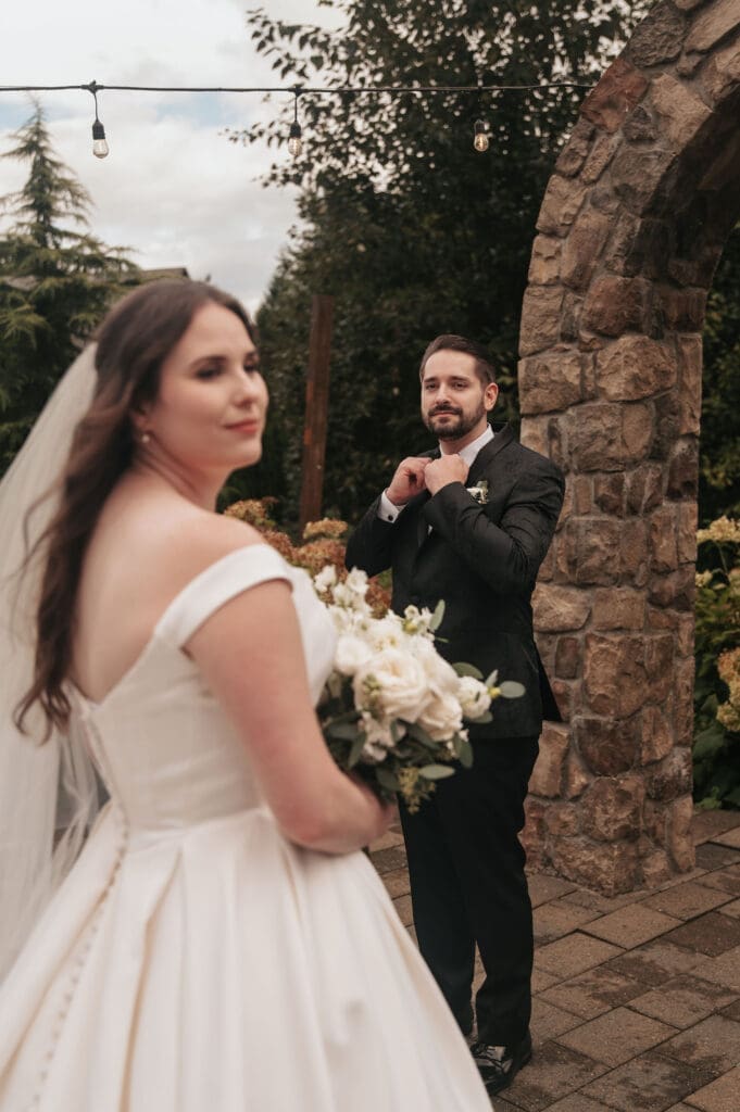 Bride and groom pose in front of stone arch in an editorial and dramatic fashion at Cape Horn Estate in Stevenson, WA.
