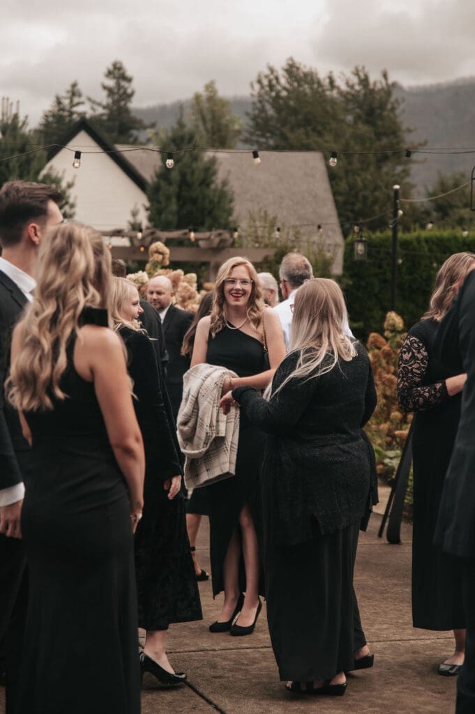 Guests mingling and talking prior to wedding ceremony.