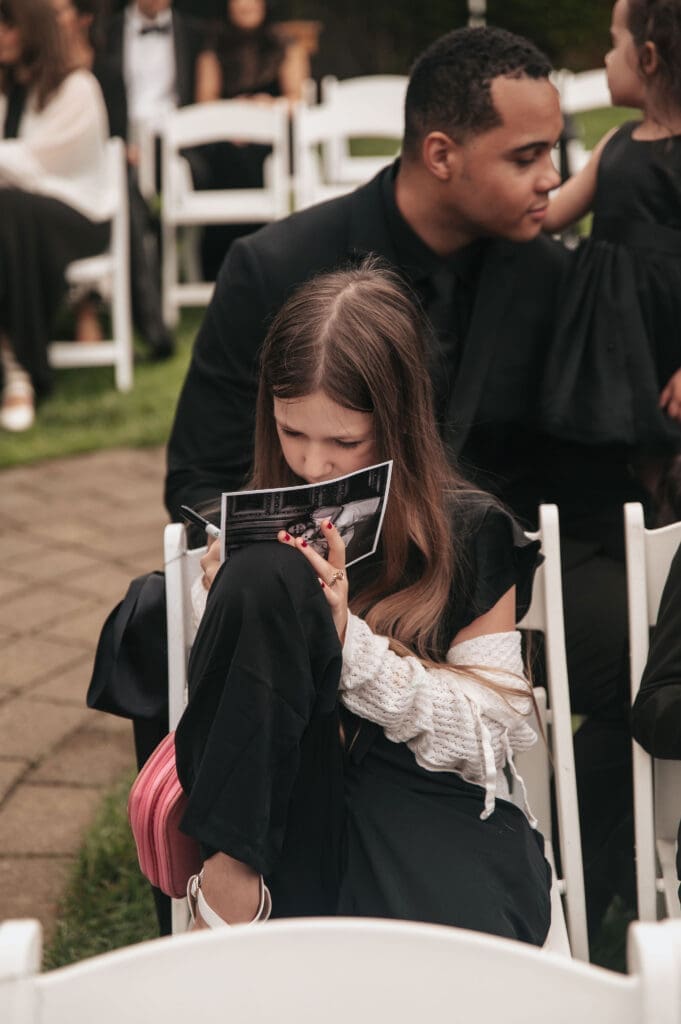 One of the wedding guests writing a message to the couple via postcard prior to Cape Horn Estate wedding ceremony.