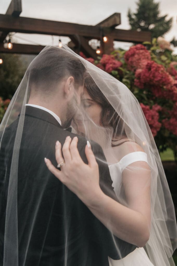 newlyweds.jpg Intimate portrait of bride and groom beneath wedding veil during Cape Horn Estate celebration