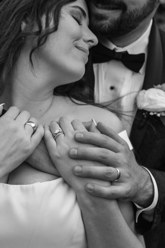 Black and white portrait of bride and groom embracing during Cape Horn Estate wedding.