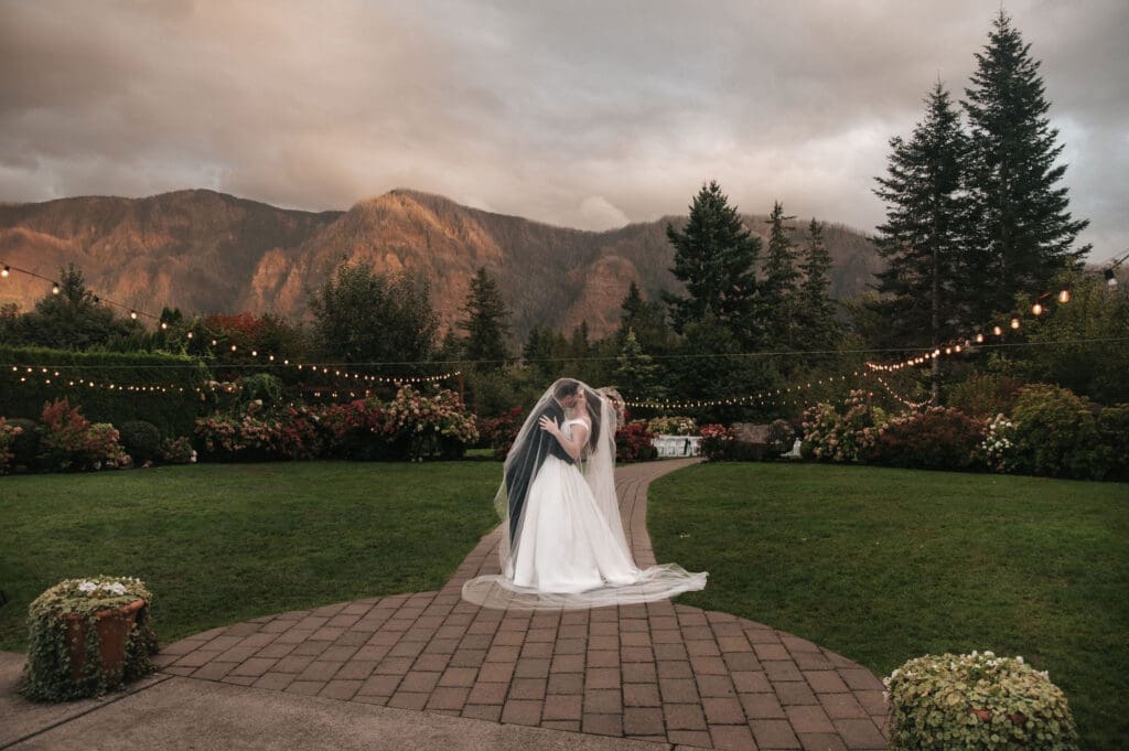 Romantic bride and groom portrait with mountain views at sunset at Cape Horn Estate wedding.
