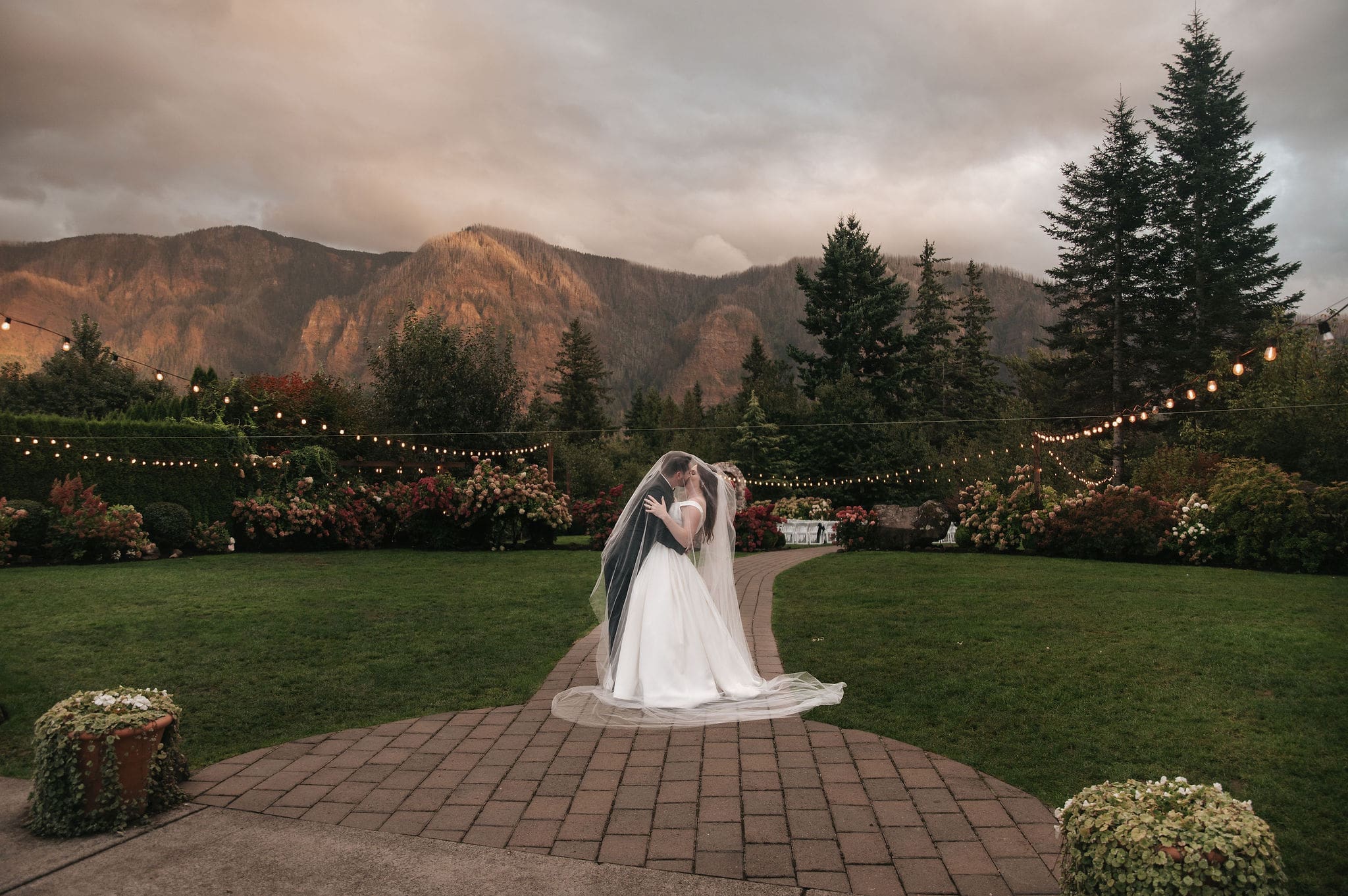 Romantic bride and groom portrait with mountain views at sunset at Cape Horn Estate wedding.