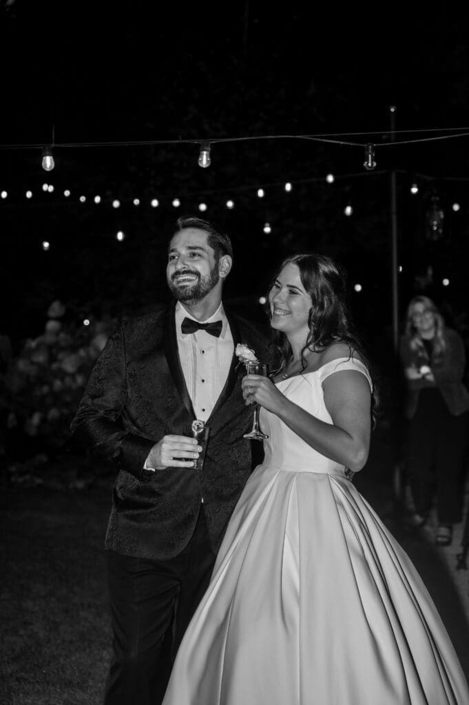 Bride and groom sharing candid black and white moment during Cape Horn Estate wedding reception