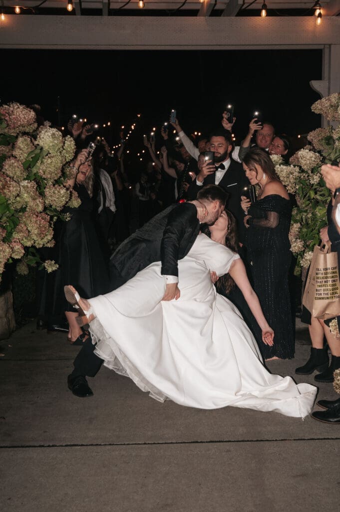 Bride and groom dipping during phone light exit at Cape Horn Estate wedding reception