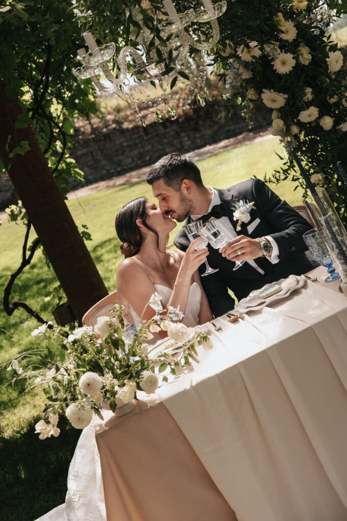 Bride and groom toasting at their wedding reception table at Villa Catalana Cellars luxury wedding venue near Portland, Oregon.