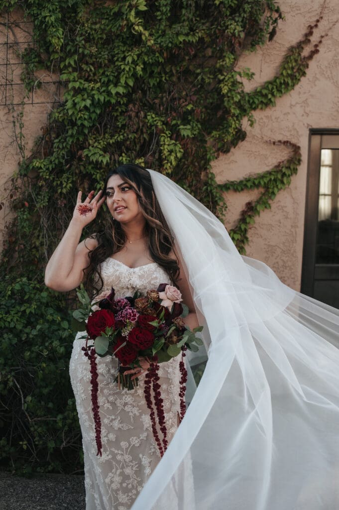 Bride holding bouquet outside The Paseo Venue during a luxury Arizona wedding.