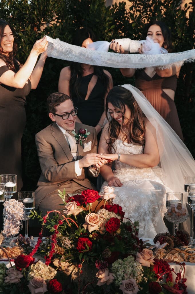 Bride and groom exchange rings during Persian ceremony at The Paseo. 
