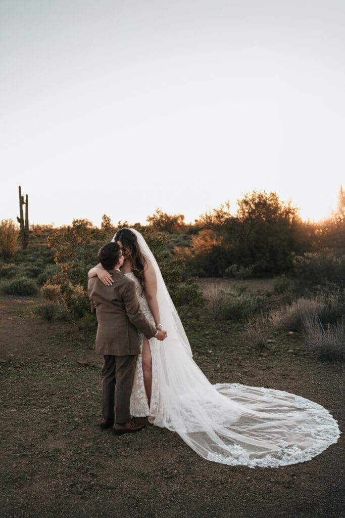 Bride and groom embracing during golden hour portraits at The Paseo Venue in Apache Junction Arizona