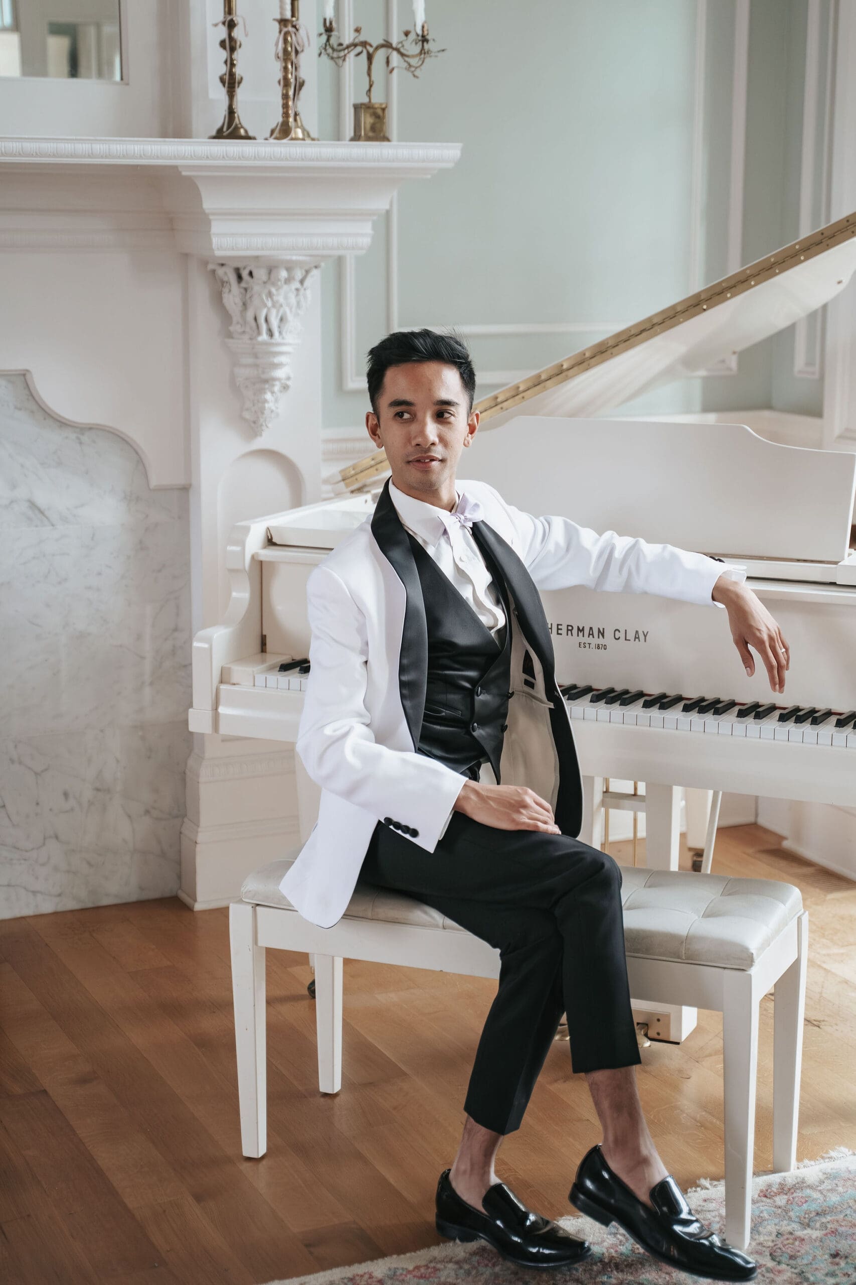 Groom near piano at his HappiMiss Lavender wedding