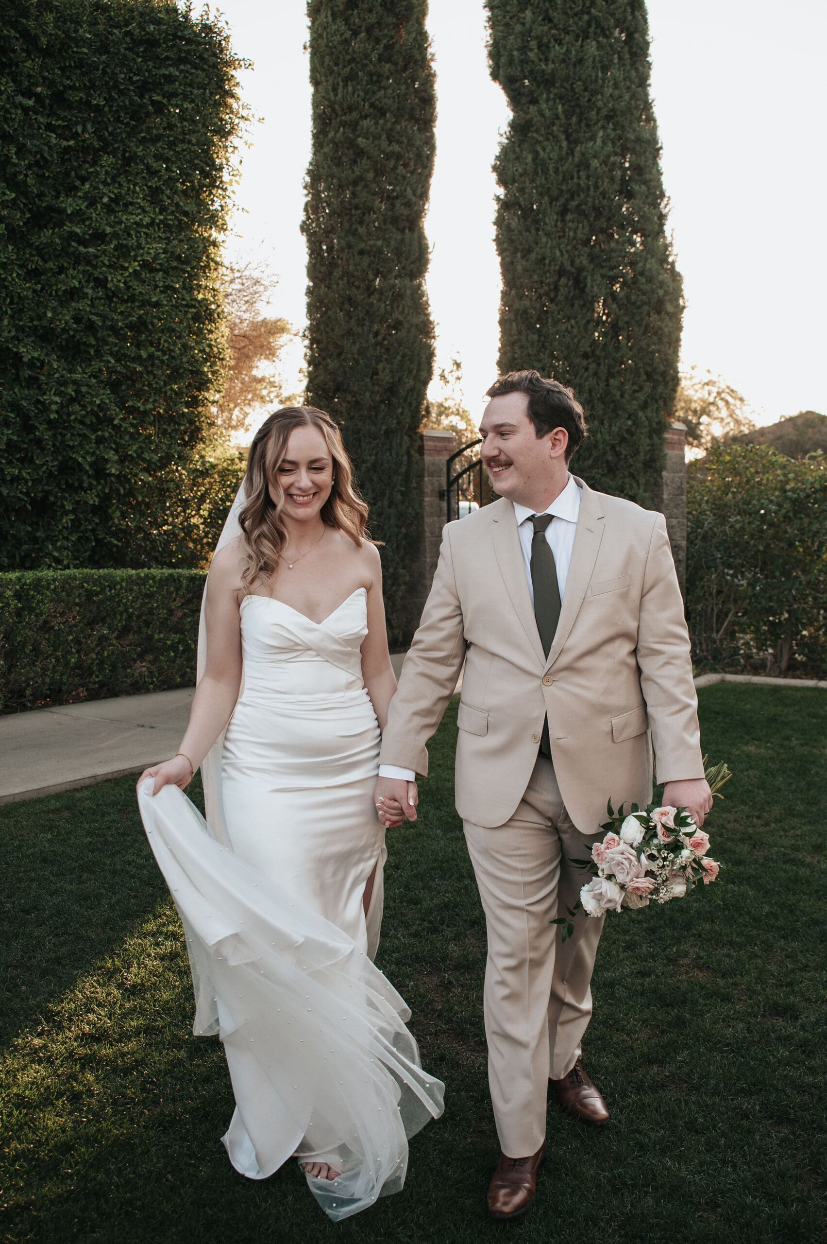 Bride and groom hold hands at their Stonebridge Manor wedding